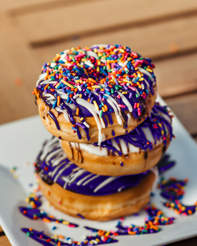 A box of purple donuts